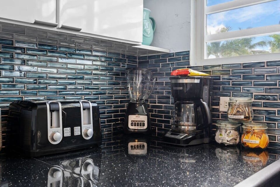 The kitchen features a stove, oven, microwave, full-size refrigerator and freezer, coffee maker, toaster, and a blender.