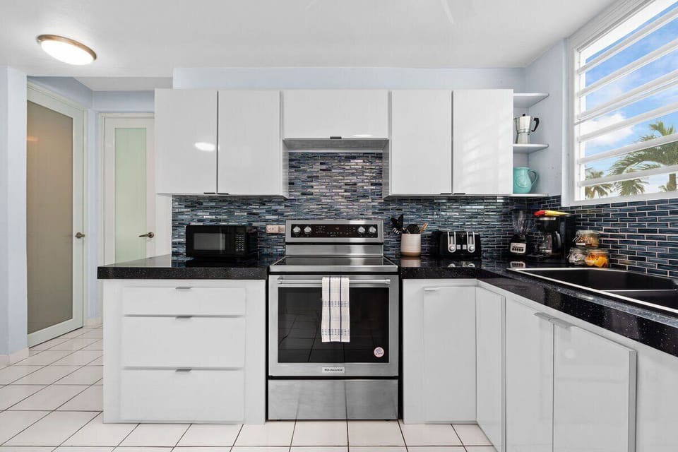 The kitchen features a stove, oven, microwave, full-size refrigerator and freezer, coffee maker, toaster, and a blender.