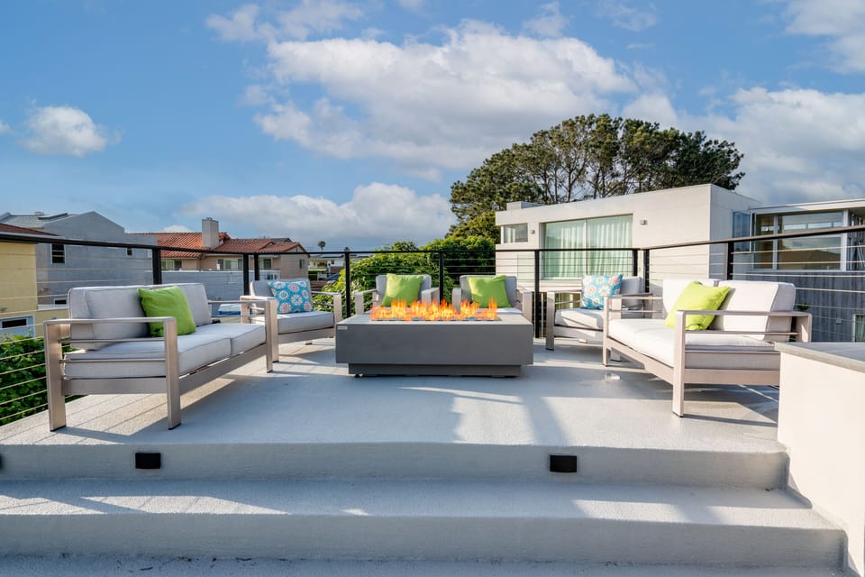 Full furnished roof top deck - seating, firepit, umbrella, and kitchenette.