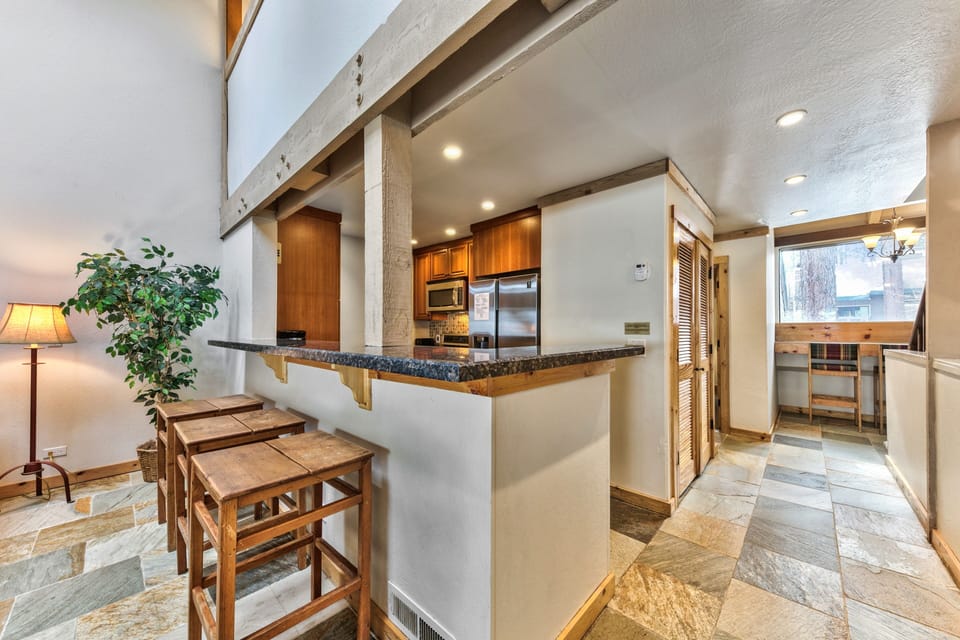 This spacious open kitchen features granite counters, stainless appliances, and a breakfast bar where you can enjoy morning coffee in comfort.