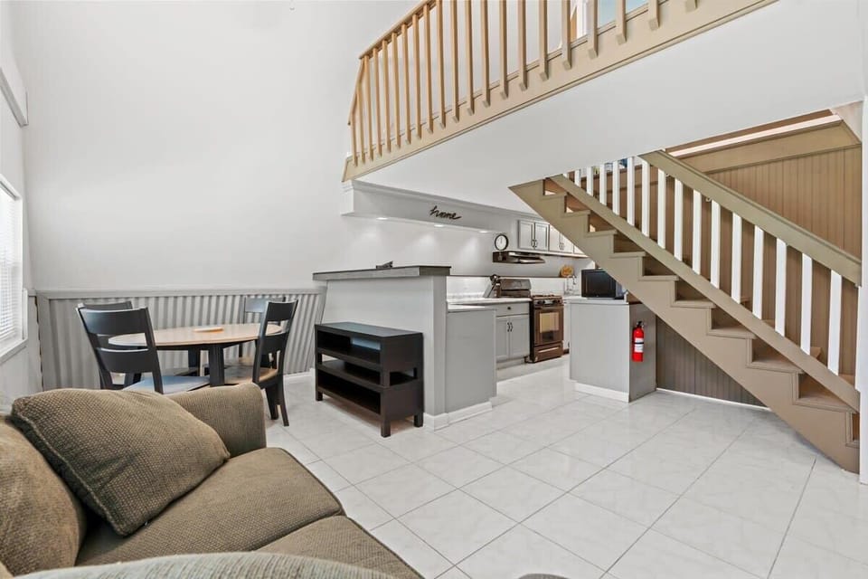 Bright living, kitchen, and lofted ceiling—easy flow for lounging and cooking.