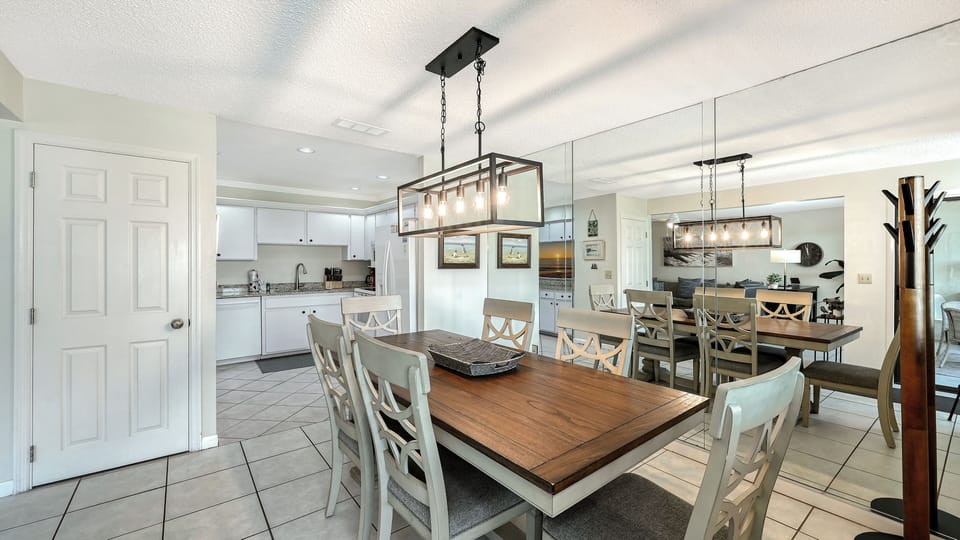 Gather around the spacious dining table for meals and memories, with a fully equipped kitchen at your side and bright, welcoming light throughout your home away from home.