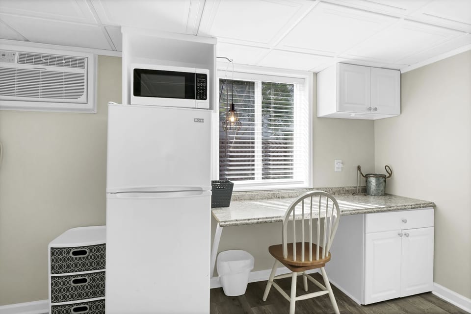 studio with freezer, microwave and desk