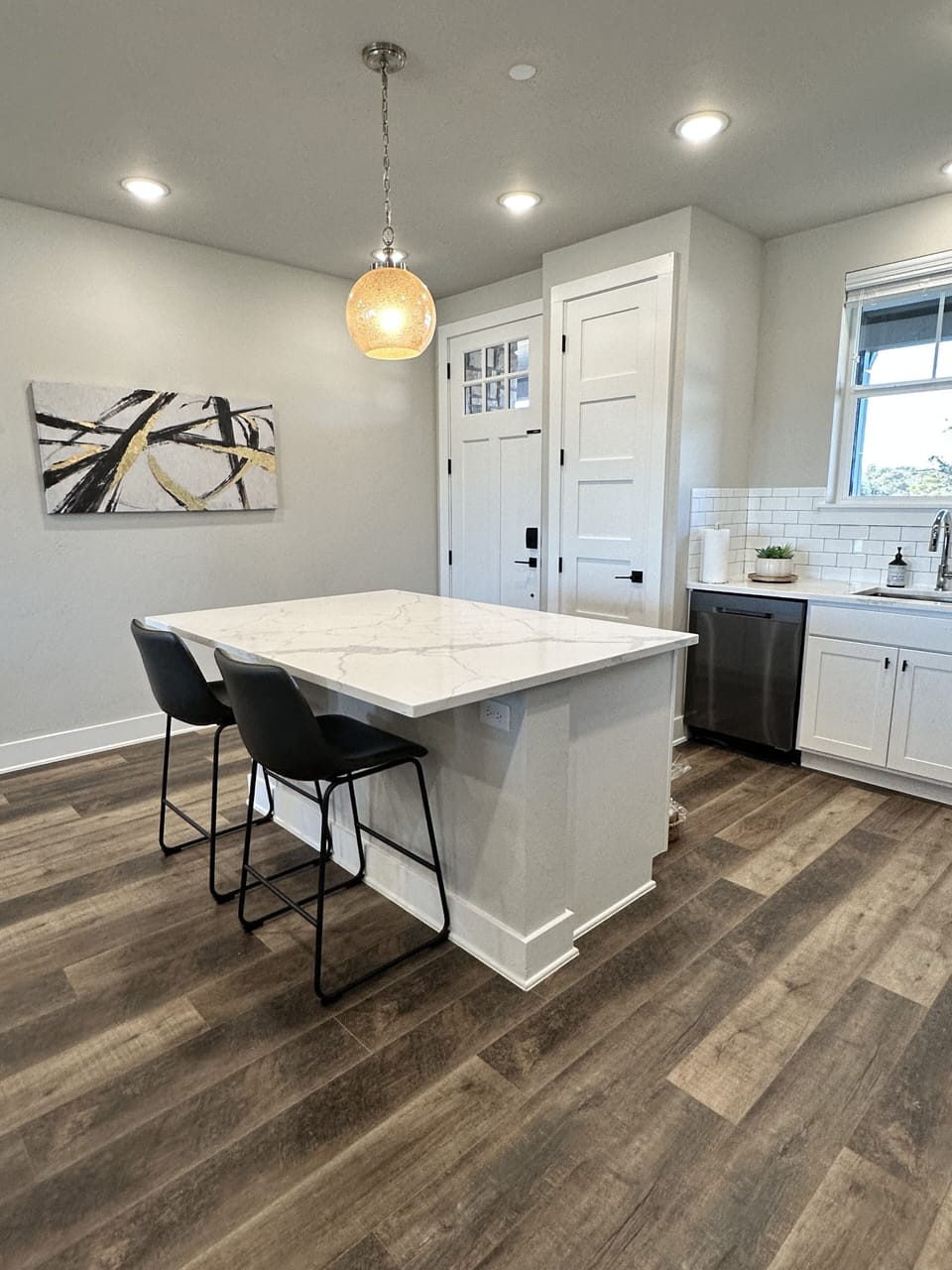 Condo entry into the fully equipped kitchen with island seating