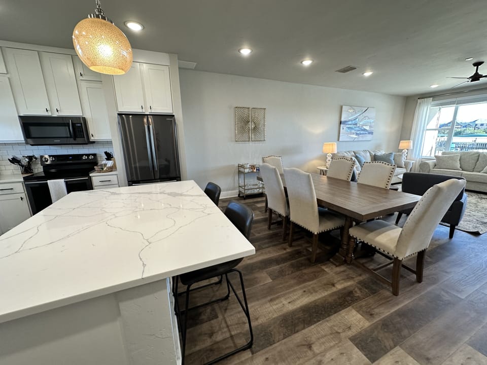 Kitchen open to the dining room with views of the pool and lake