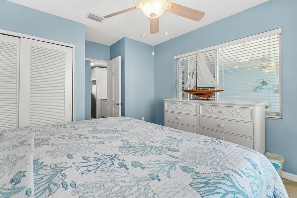 Rest peacefully in your coastal-themed bedroom, where nautical blues and gentle ceiling fan breezes create your perfect seaside retreat.