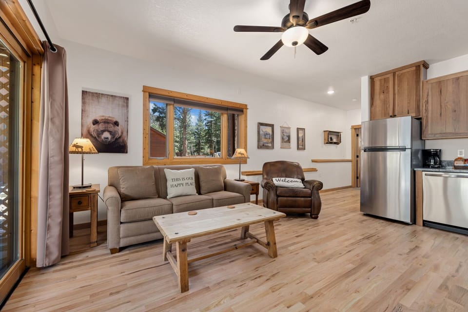 Relax in your cozy living space with rustic charm, complete with forest views from your window.