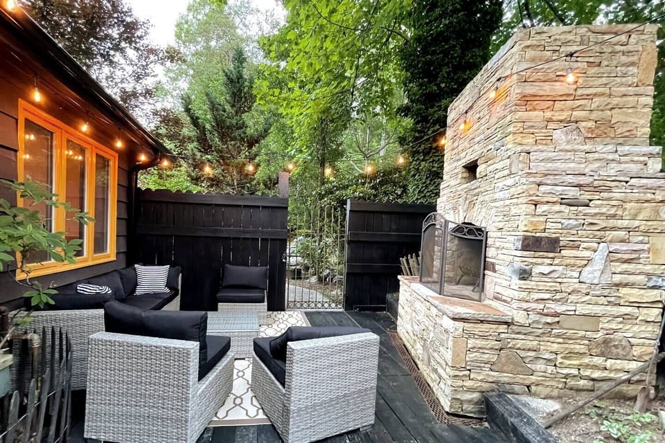 Cozy Outdoor Stone Fireplace with Patio Seating on the Deck—Perfect for Relaxing & Enjoying Mountain Life!