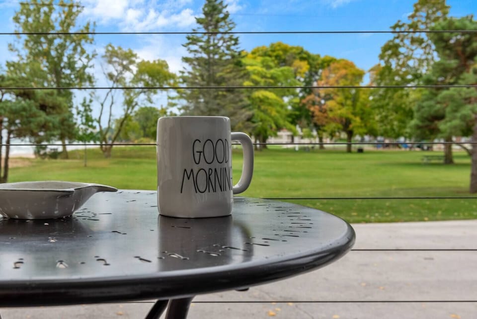 Enjoy a peaceful cup of coffee w/ a green, open view.