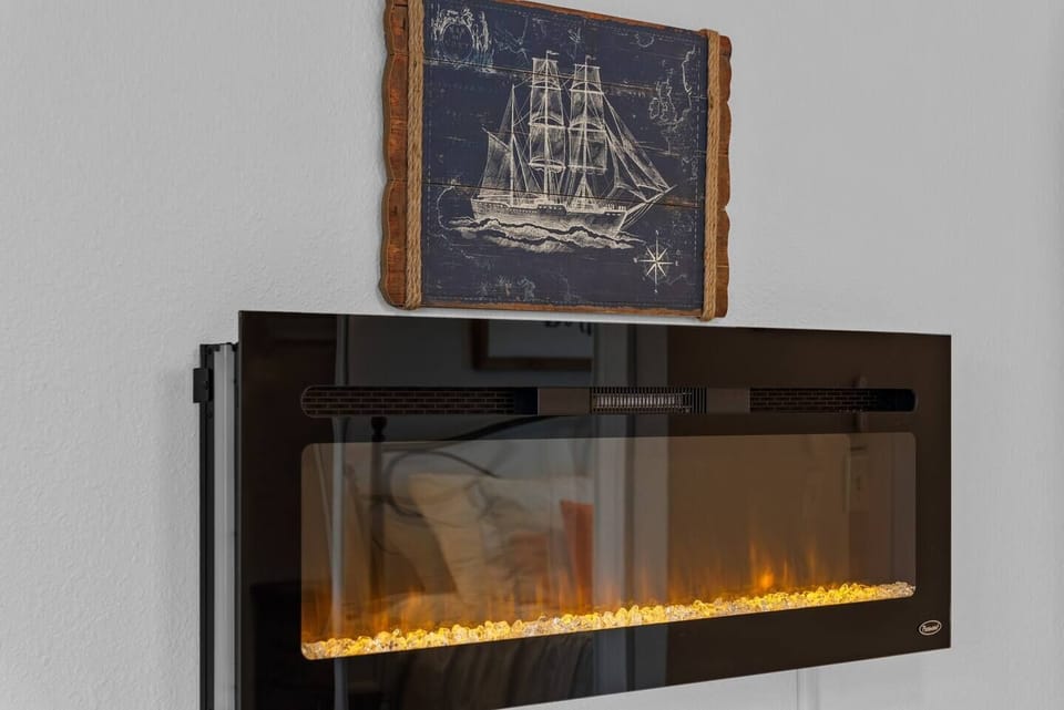 Electric fireplace creates a cozy vibe for relaxed evenings.