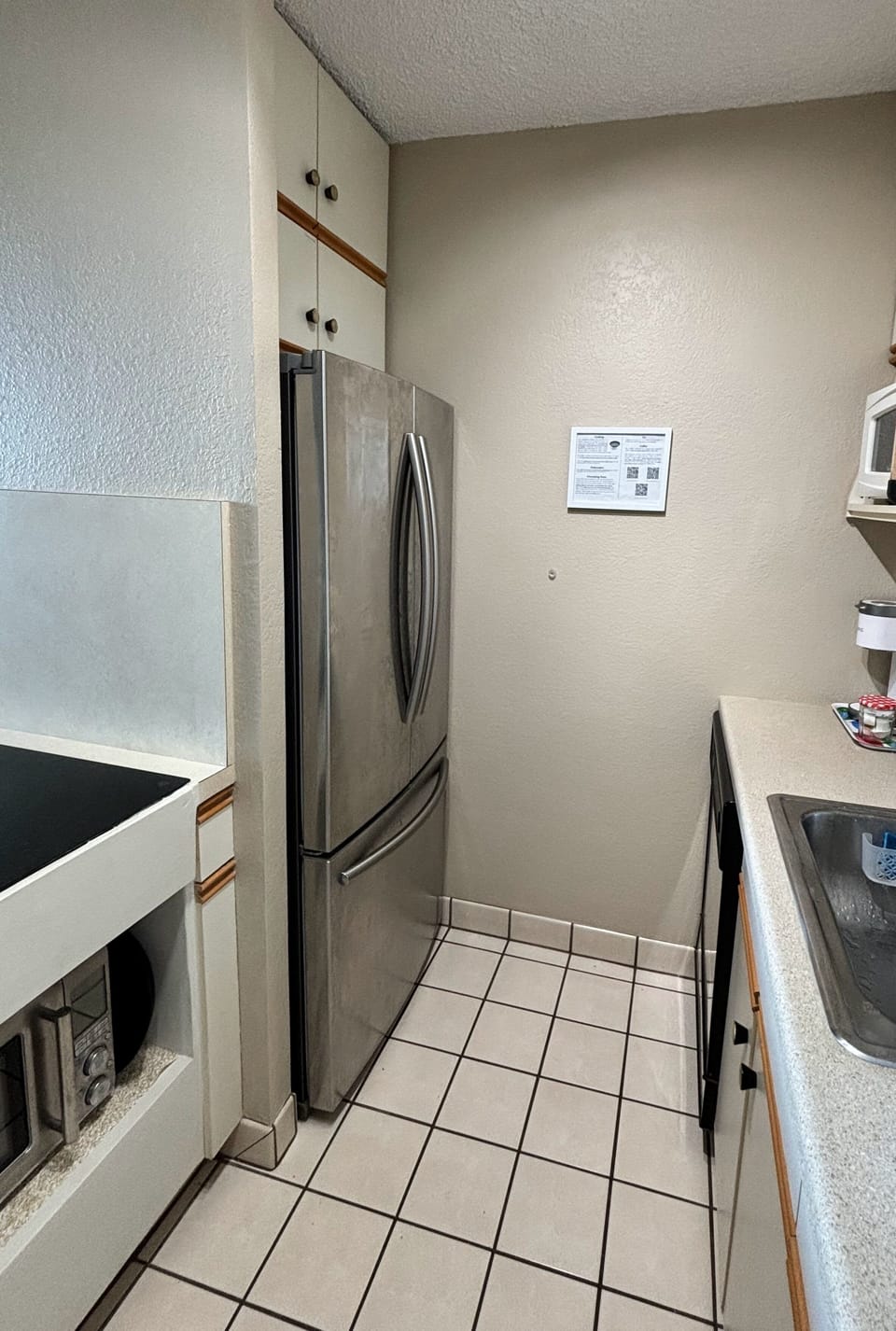 The kitchen has a large refrigerator, dishwasher, microwave, and combi oven.
