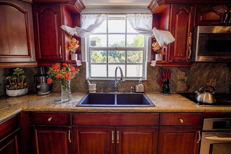 Cook with ease in a fully equipped kitchen featuring rich wood cabinetry and views