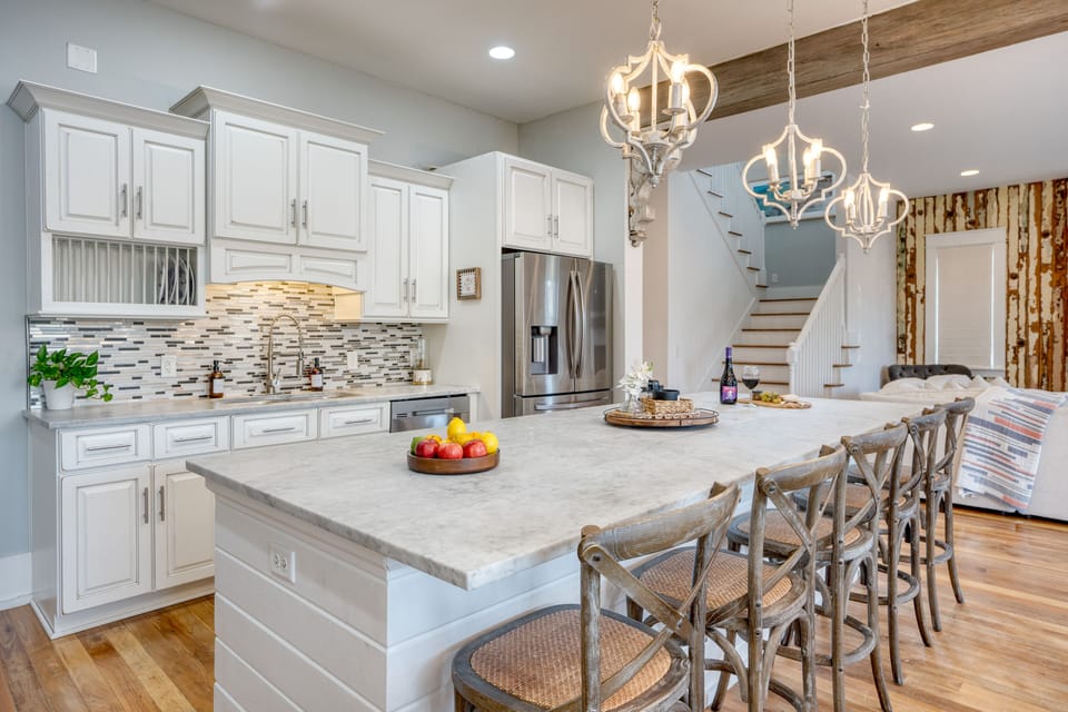 Large island in the kitchen with 5 barstool seats.