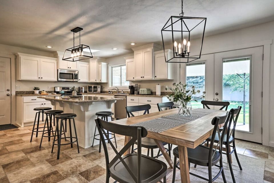 Open dining and kitchen area with modern lighting, seating for the whole group, and everything you need to cook at home.