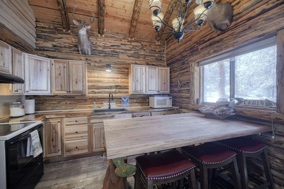 Spacious kitchen workspace with natural light, wood cabinetry, and ample counter space.