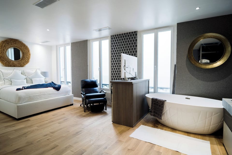 Bedroom 2 - Beautiful second bedroom with an ensuite, standing bath tub, walk in closet, love seat, and television. 