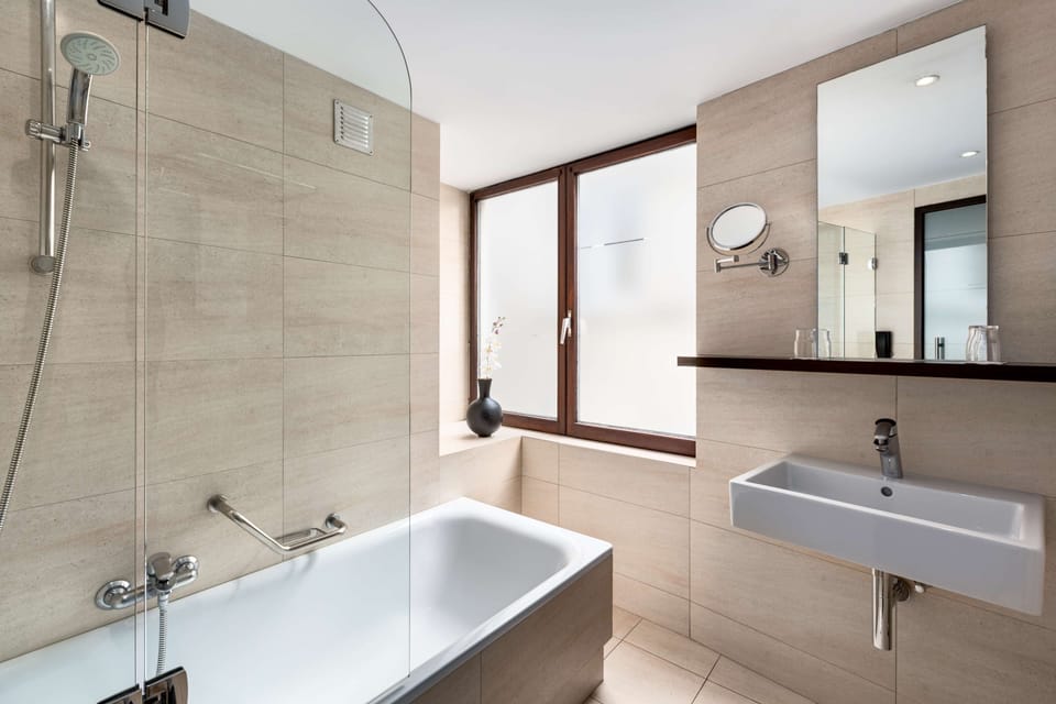 Deep soaking tub, rainfall showerhead, eco-friendly toiletries