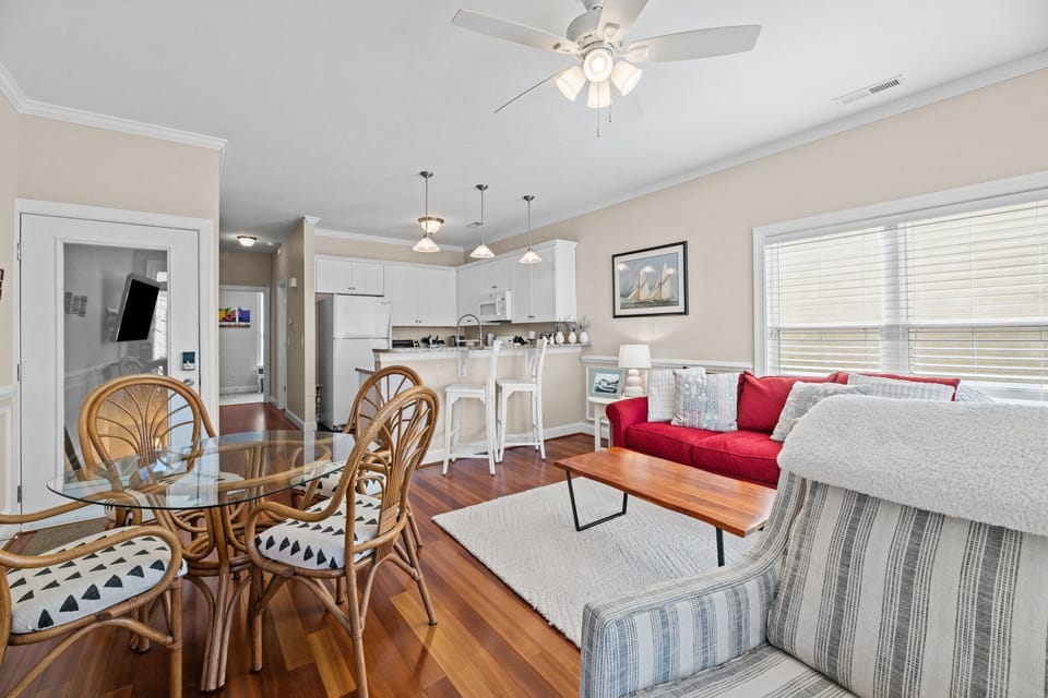 An open concept living space blending into a small yet fully equipped kitchen. 