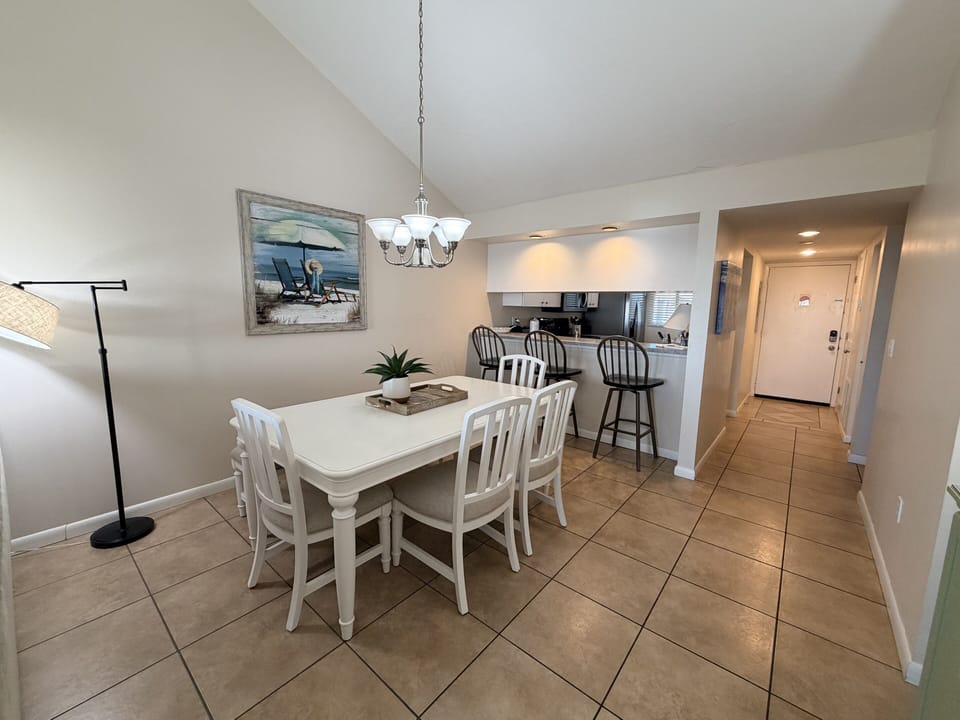 Gather around your bright dining table for memorable meals, with coastal artwork and an open kitchen perfect for vacation conversations.
