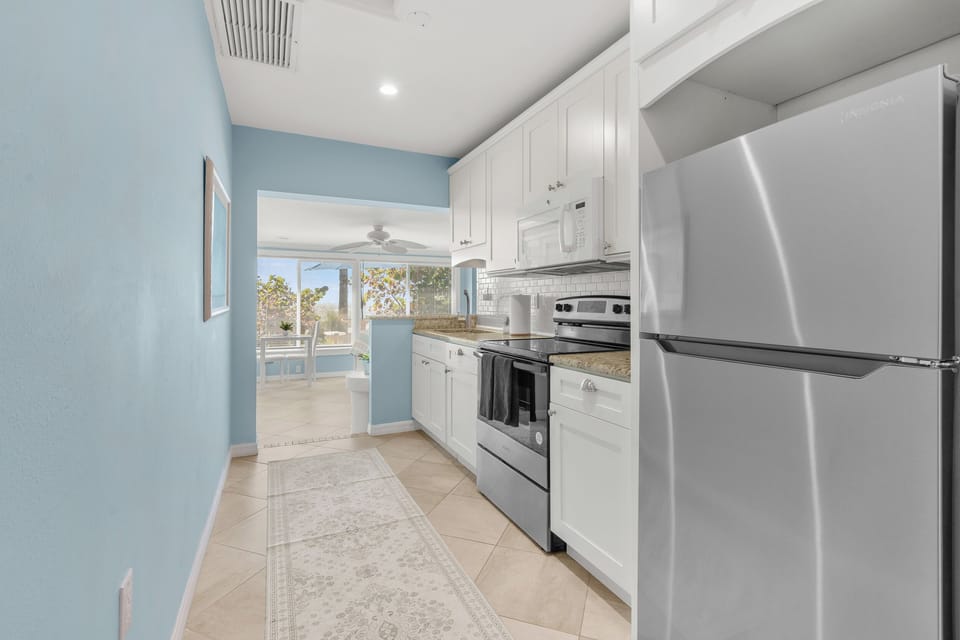 You'll love cooking in this bright, fully-equipped kitchen with stainless steel appliances and coastal blue walls.