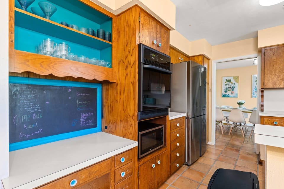 Step back in time and immerse yourself in the authentic charm of the 1960s kitchen, boasting original built-ins for a nostalgic stay.