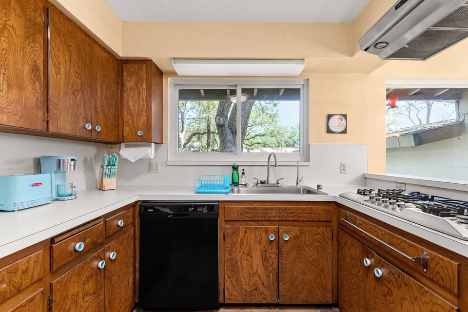 Relive the nostalgia of childhood memories in the1960s kitchen, where authentic vintage laminate countertops evoke a sense of bygone days.