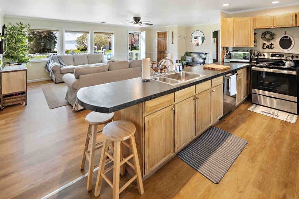 Step into our bright, open kitchen where generous counter space and cozy bar seating make cooking and conversation go hand in hand. 