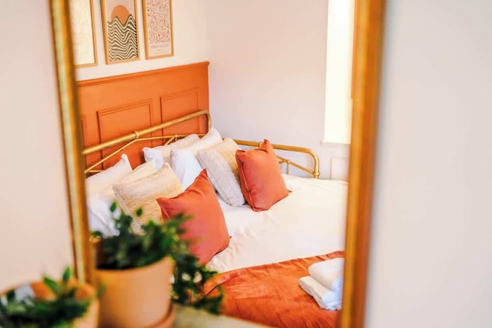 Bright and adaptable. This cozy bedroom features flexible sleeping arrangements (1 king bed or 2 singles) styled with warm terracotta accents and a lovely country view.