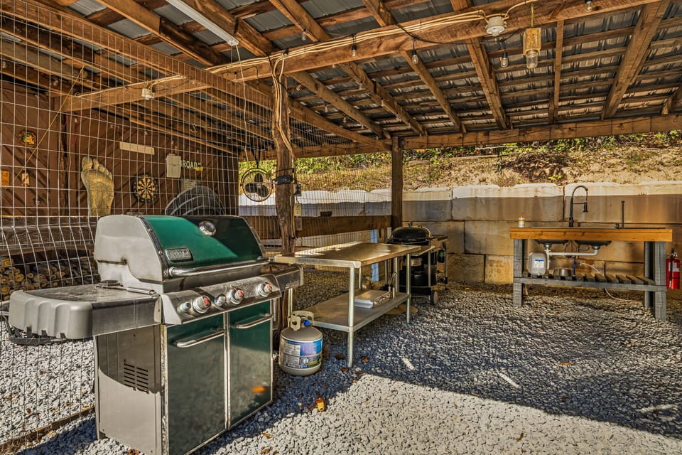 Outdoor entertaining space with Weber gas and charcoal grills and sink. 