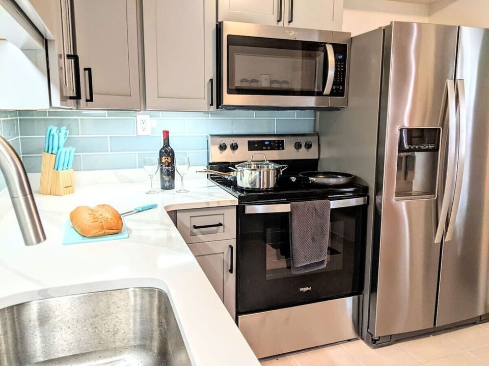 The kitchen is fully equipped with pots, pans, and other necessary items.