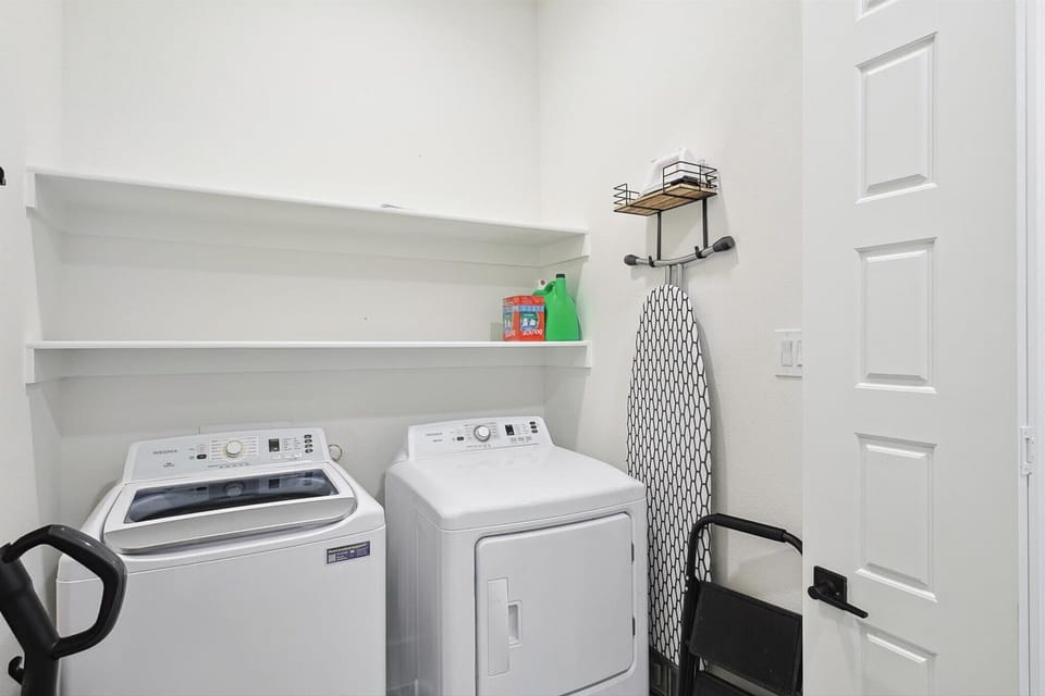 Relish the flexibility of ensuite laundry with this washer and dryer set. Additional amenities include an ironing board, a step ladder, and cleaning supplies.