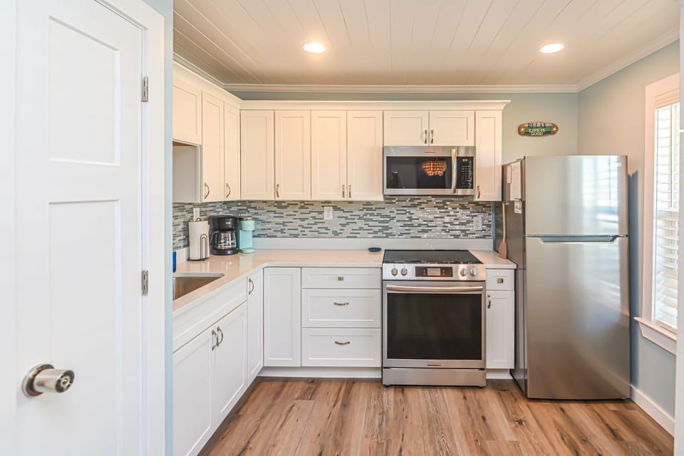 New kitchen with glass tile and quartz