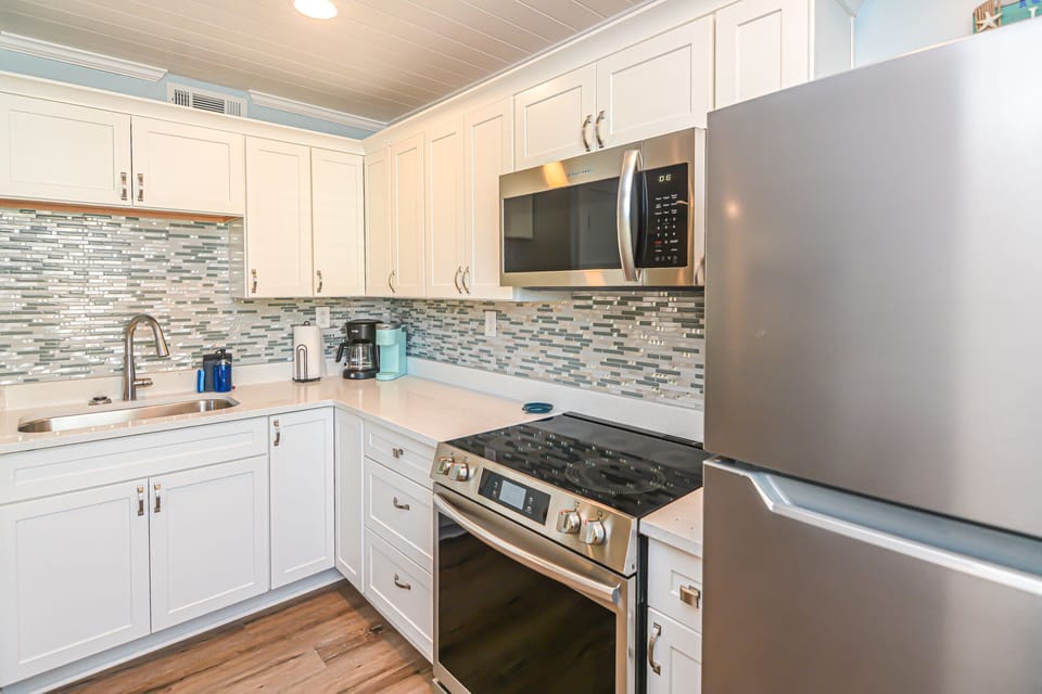 New kitchen with glass tile and quartz