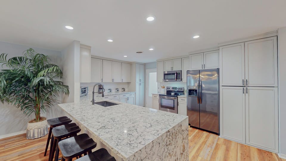 Fully Stocked Kitchen with Countertop Seatiing
