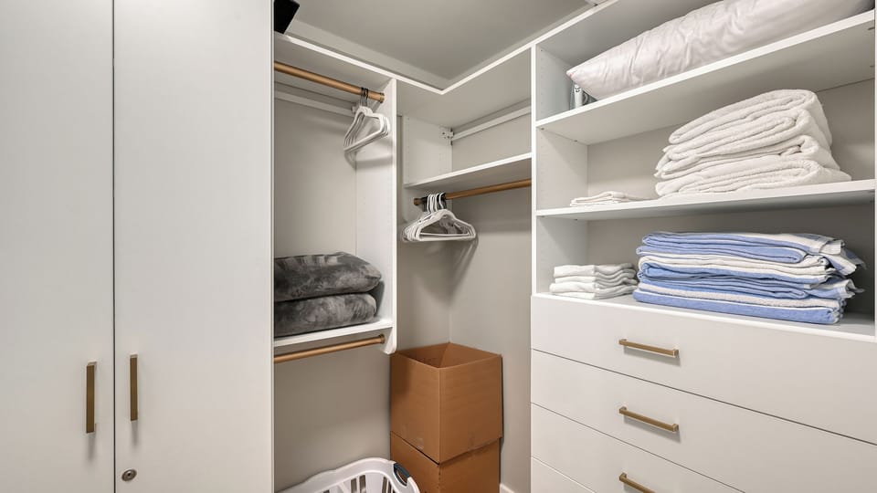 Your wardrobe is stocked with plush towels and linens, all neatly organized for your convenience and comfort.