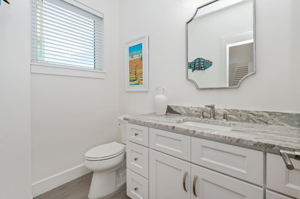 Convenient half bath located just off the kitchen.
