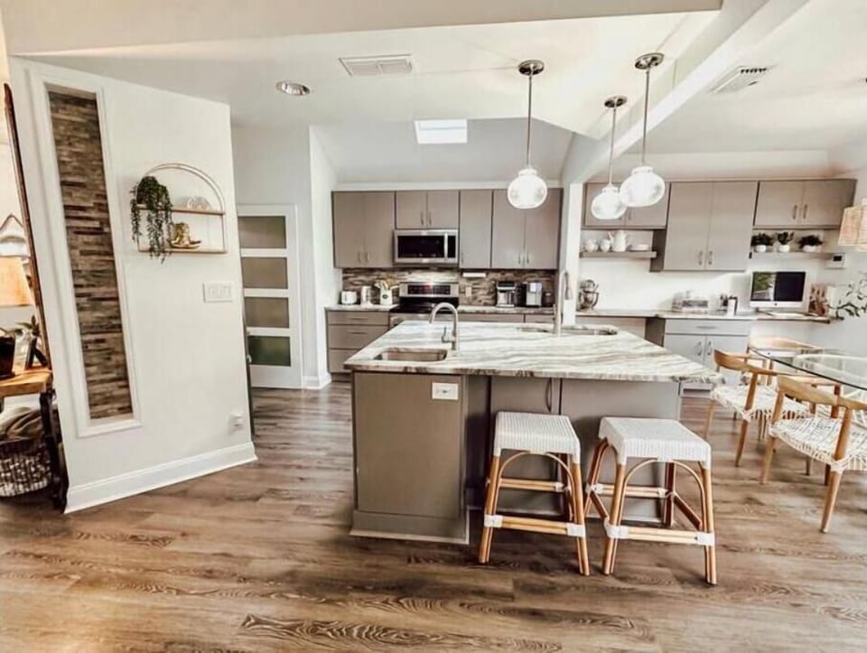 Expansive kitchen island with two sinks, opens to living & dining rooms