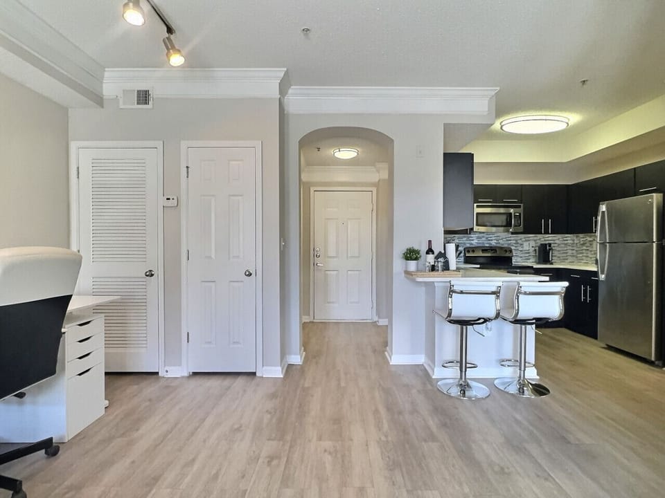Modern kitchen with a sleek dining area, perfect for cooking, serving, and enjoying meals in style during your short-term rental stay