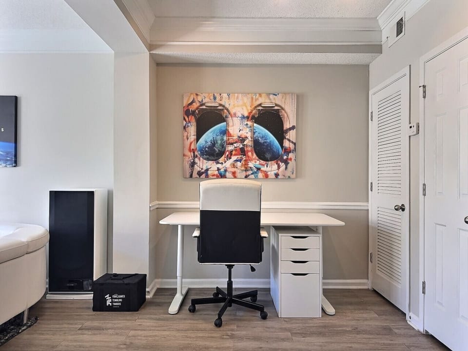A dedicated office area thoughtfully furnished with a desk and ergonomic chair, offering a pleasant and comfortable space for work or study, perfect for a short-term rental.