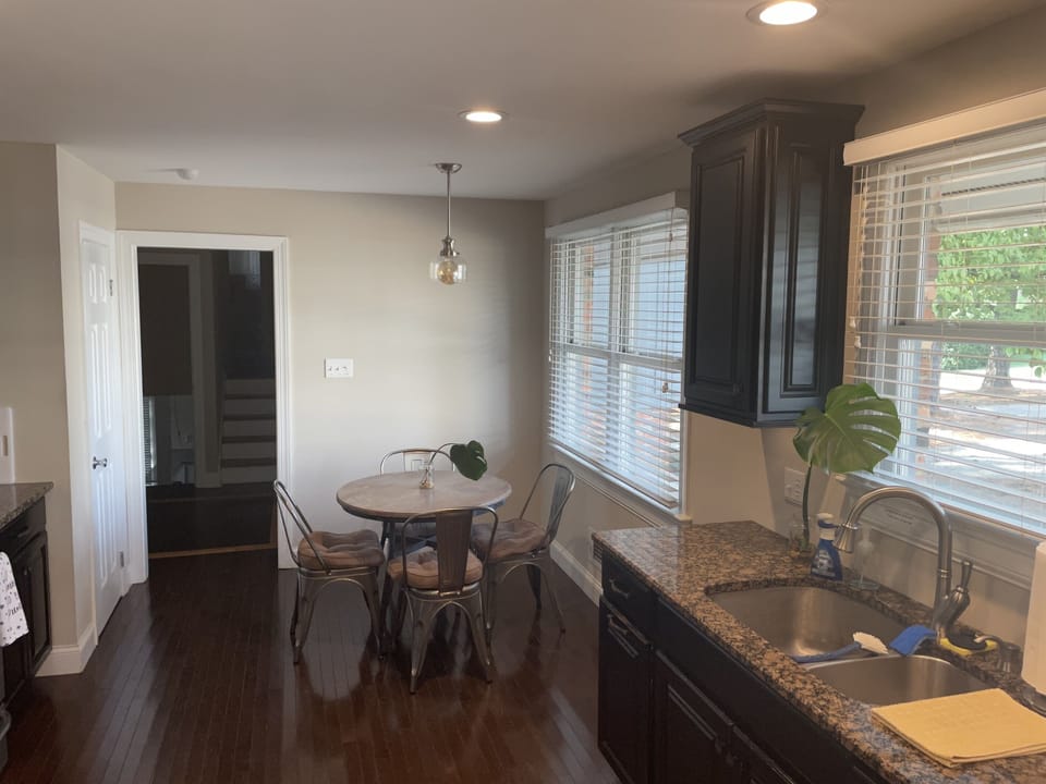 Another updated view of the kitchen with dine in table that seats 4 guests.  Another larger table in the Dining area seats up to 8 guests. 