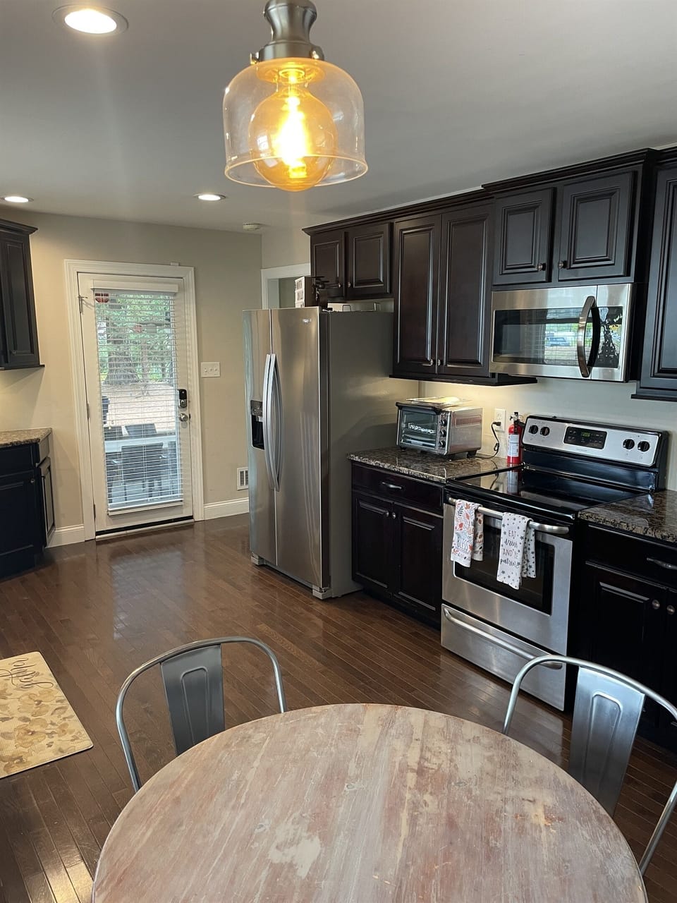 Fully stocked kitchen with stainless full sized Fridge, Freezer with ice/water in door, flat top stove/oven, toaster/air fryer to make cooking a breeze. Kitchen is also equipped with a Fire extinguisher, and first aid emergency kit for added safety.