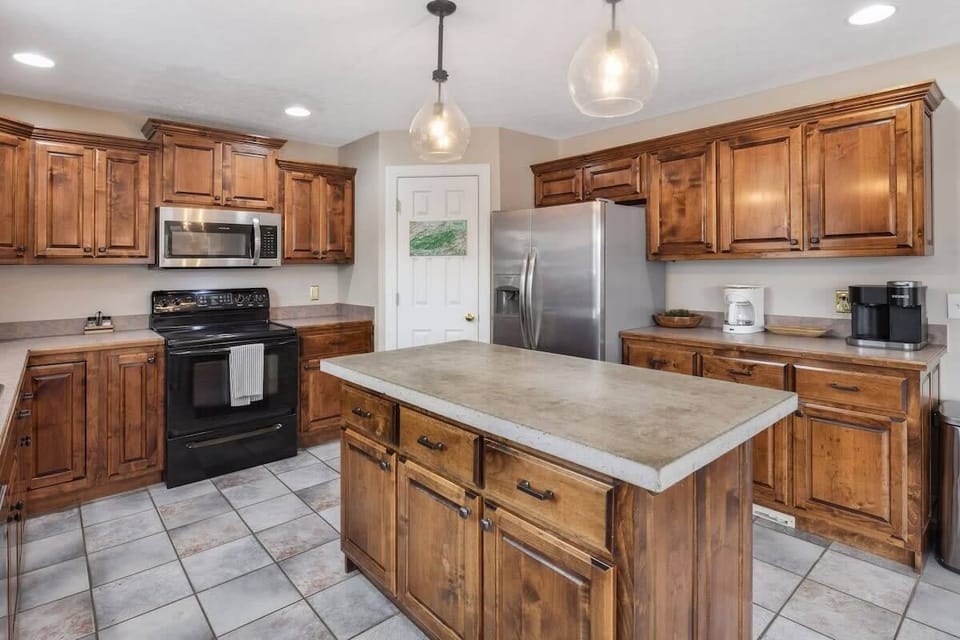 Rustic kitchen with a central island and stainless steel appliances