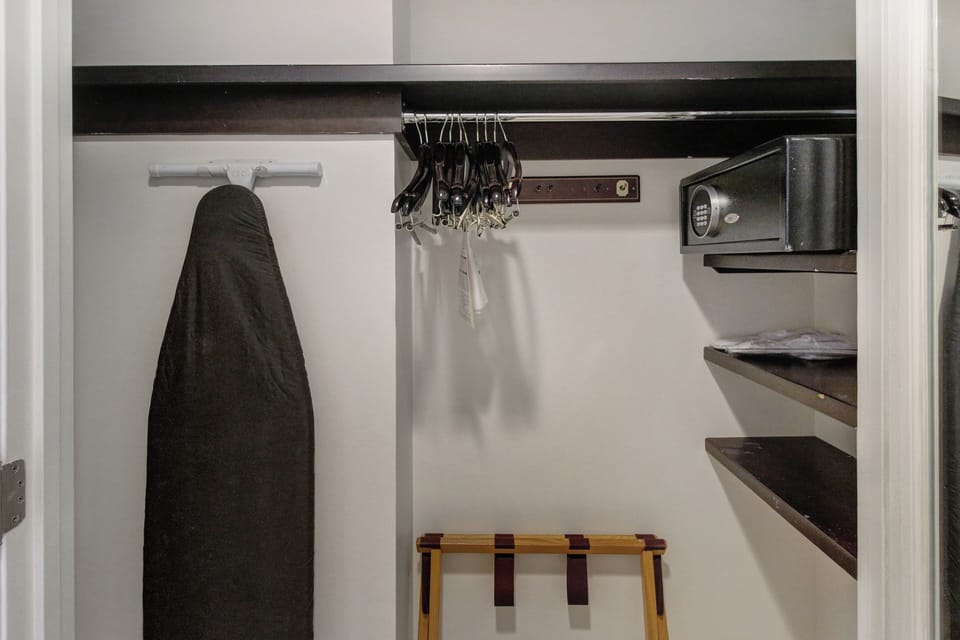 Closet with in-room safe and ironing board & iron. 