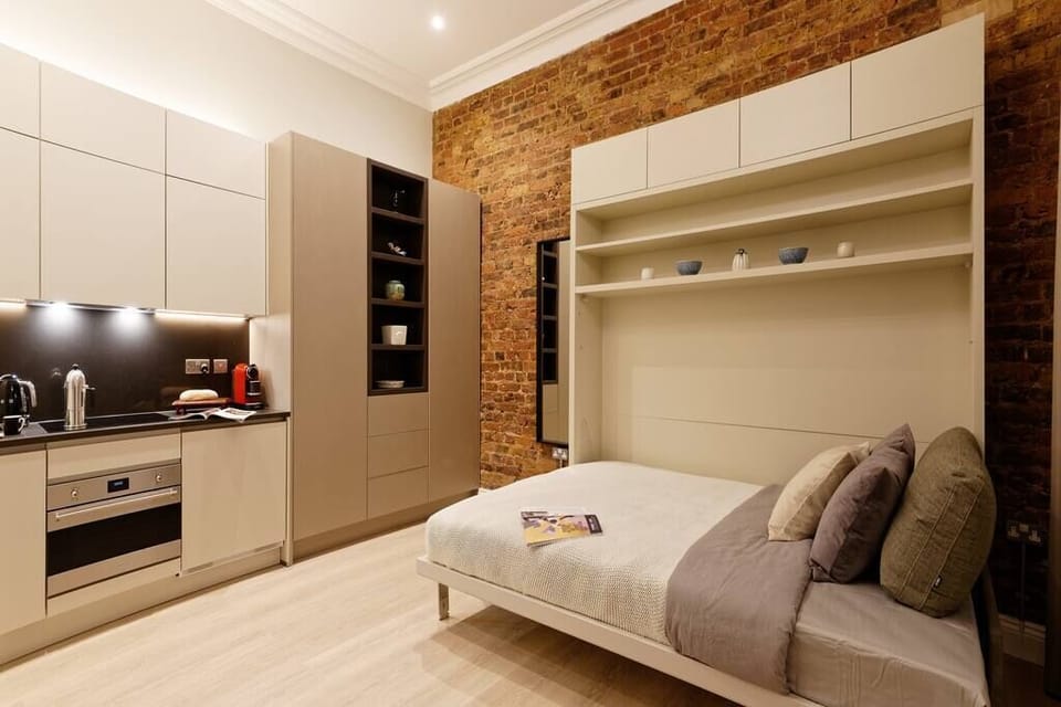 Comfortable double bed. Please, note that the bed will be open and ready for your arrival. It's a wall bed, with the newest technology available. Super convenient and space-efficient!