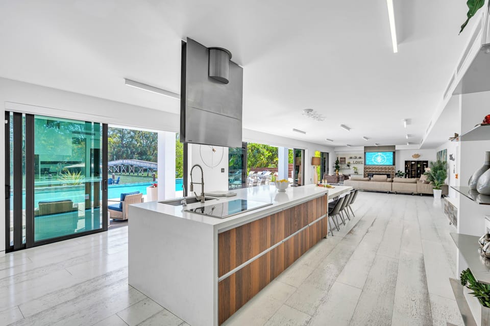 The ample open-concept chef's kitchen with waterfront view feature high end appliances and.