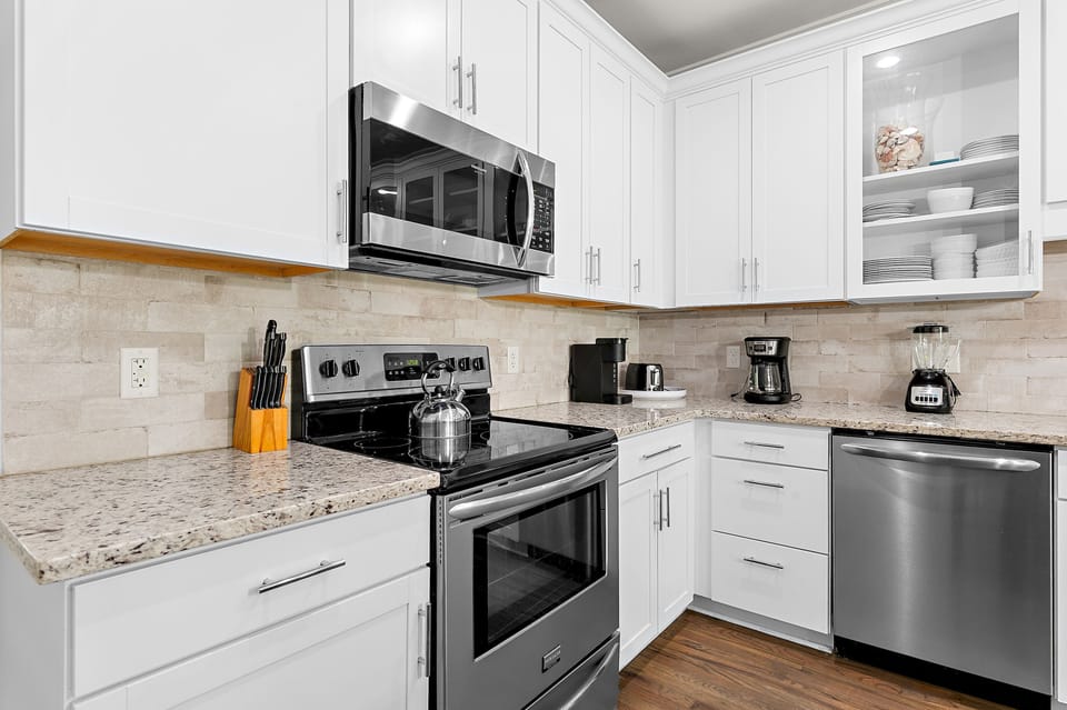 Chef-ready kitchen with a glass-top range, built-in microwave, dishwasher, and all the cookware you need for home-cooked meals.