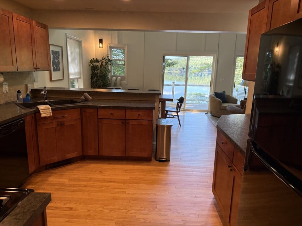 Open floor plan stocked kitchen, with lake view