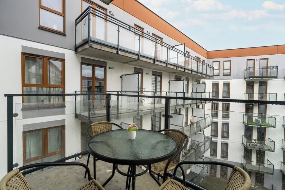 Another view of the balcony, emphasizing its spaciousness and cityscape surroundings.

