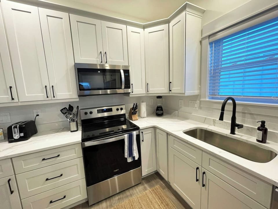 This thoughtfully equipped kitchen offers everything needed for preparing meals during your stay, including ample counter space and modern appliances.