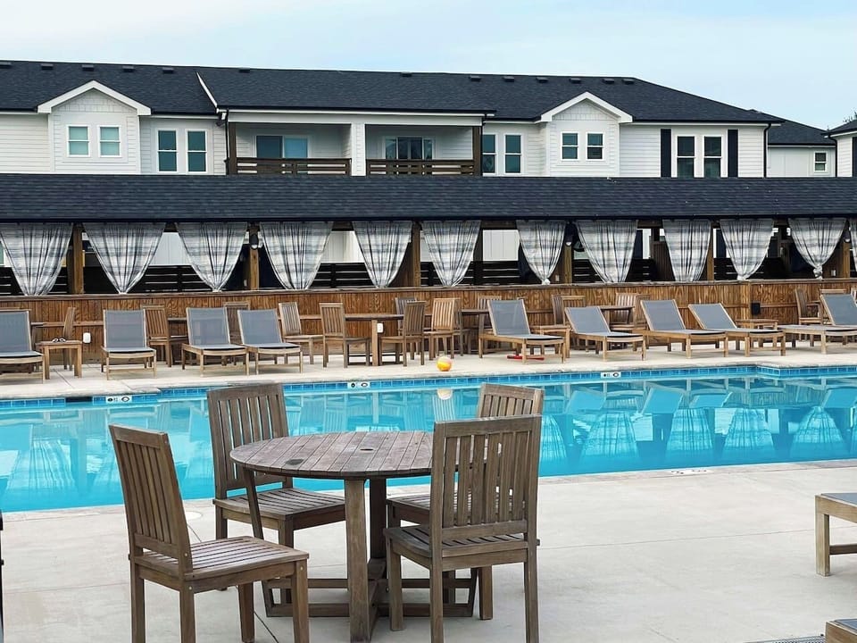 Take in the resort amenities with this expansive heated pool, surrounding sun loungers, and relaxing shared outdoor spaces.